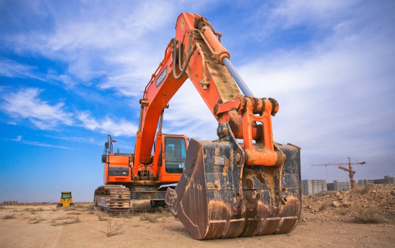 pexels-photo-1078884 Low Angle Photography of Orange Excavator Under White Clouds